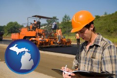 michigan map icon and a paving contractor with paving machinery