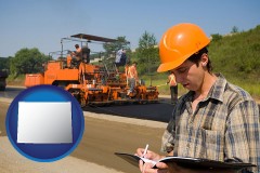 wyoming map icon and a paving contractor with paving machinery